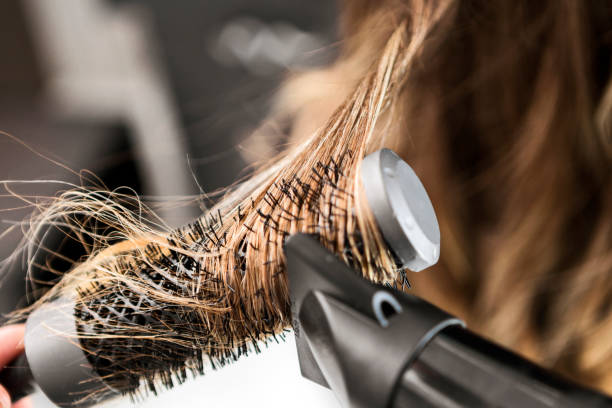 Young woman at a hair salon with hairdresser ,hair drying